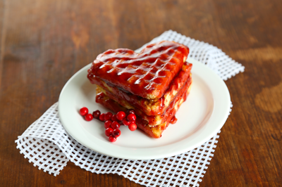 Heart-shaped waffles topped with strawberry sauce